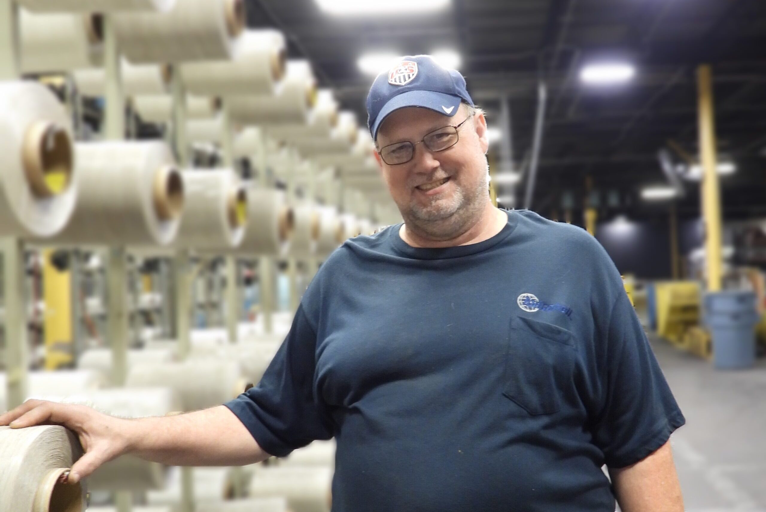 Twitchell team member working with fabric