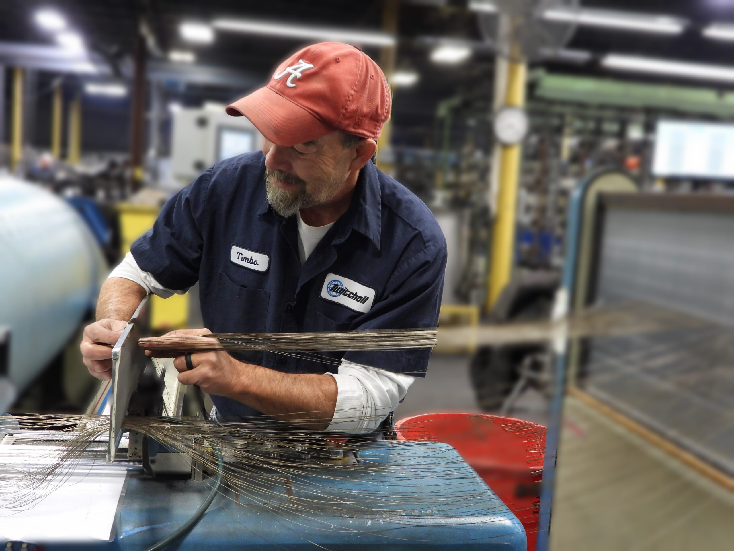 Twitchell employee working with fabric on the manufacturing floor